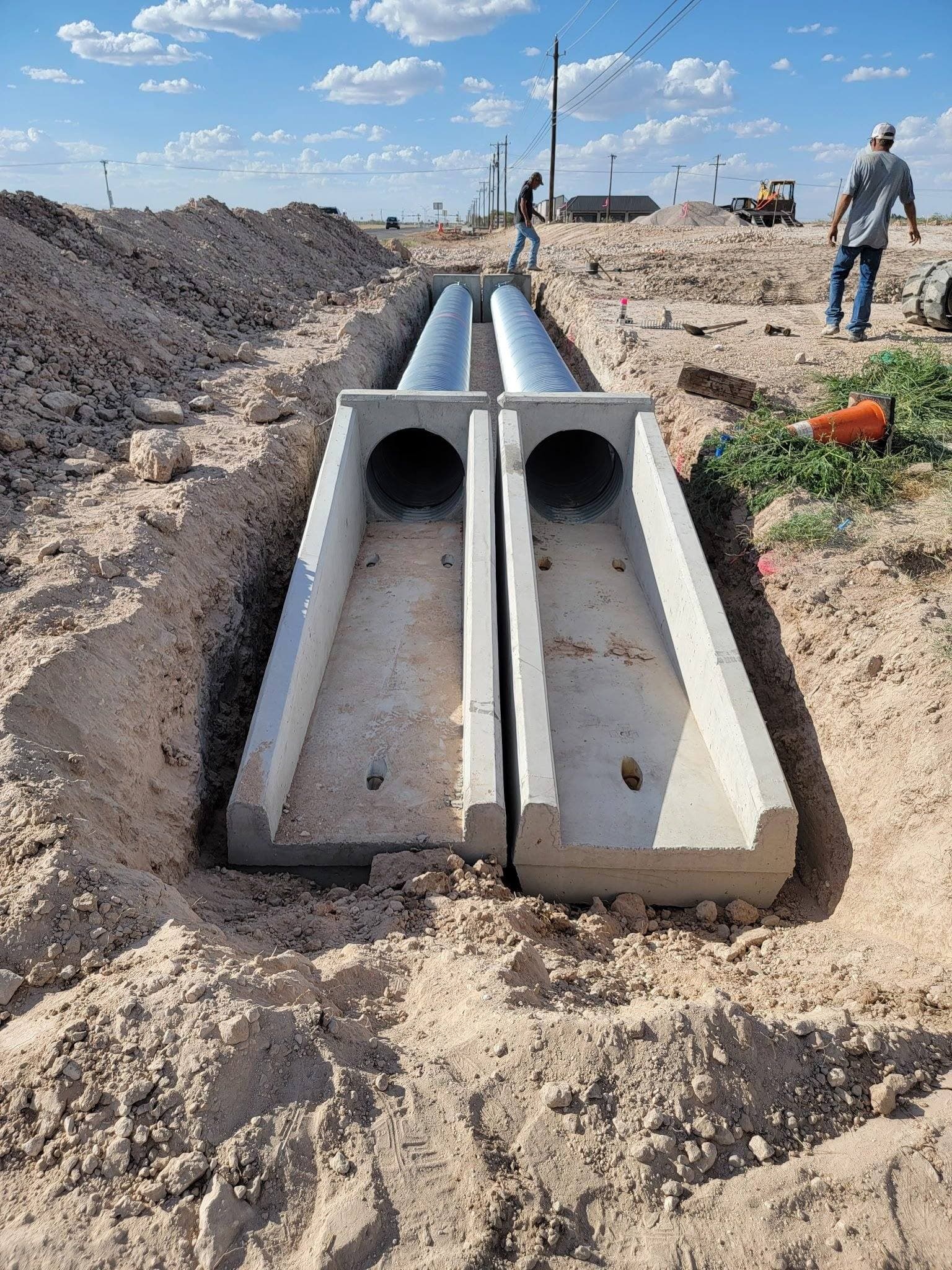 Twin concrete culverts installed in a trench crossing