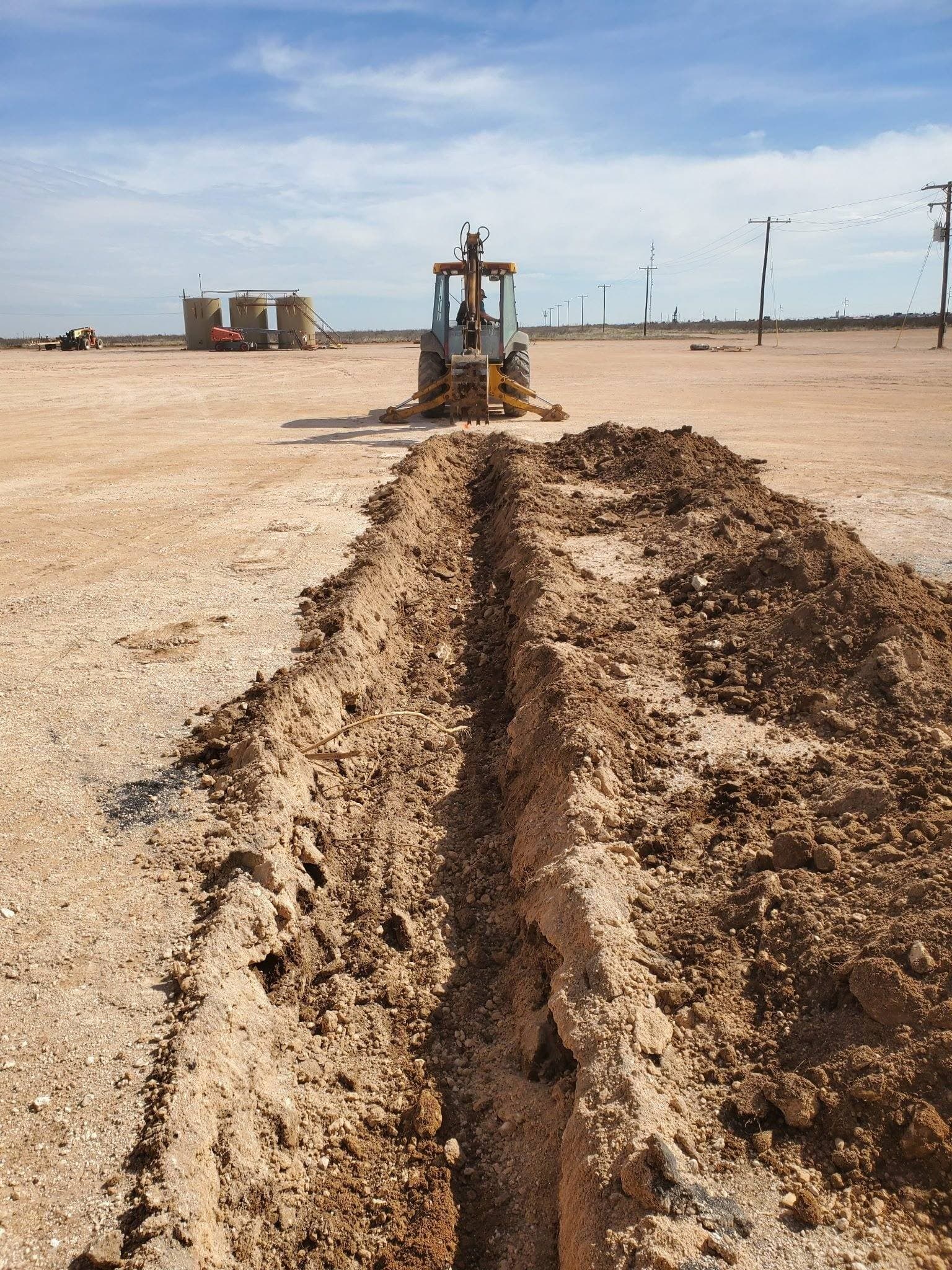 Drainage trench cut through property to redirect water flow