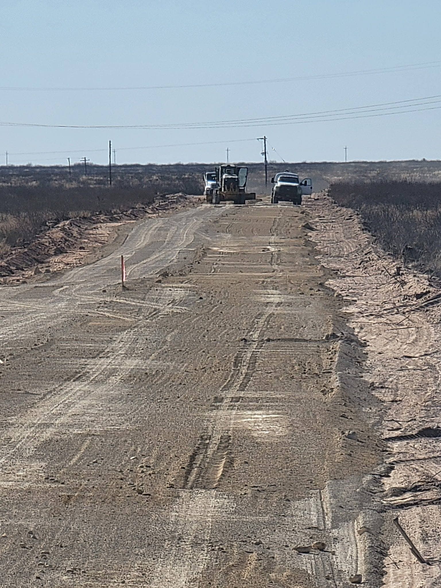 Dozer and trucks building a ranch road