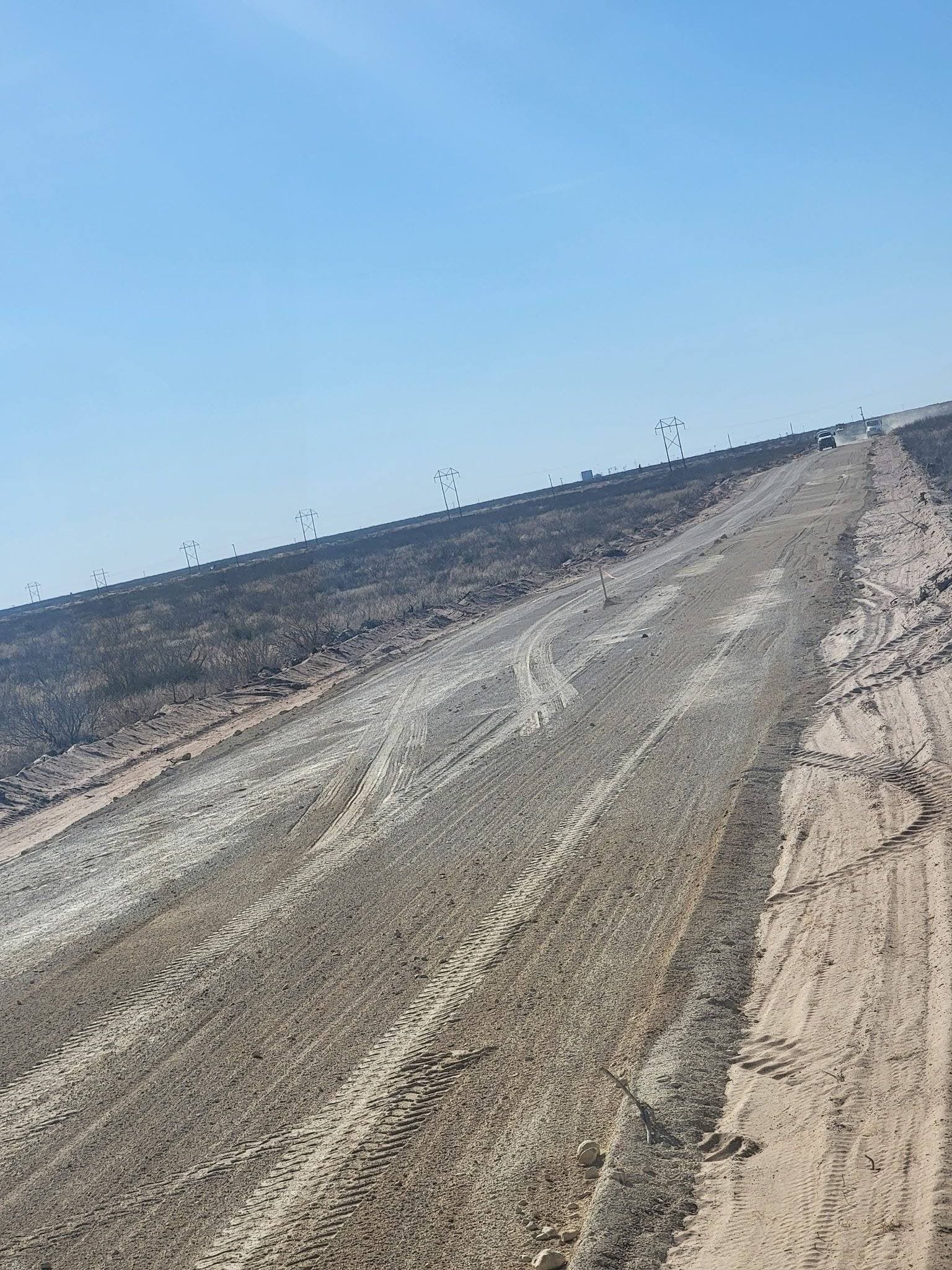 Wide caliche driveway grading with crown
