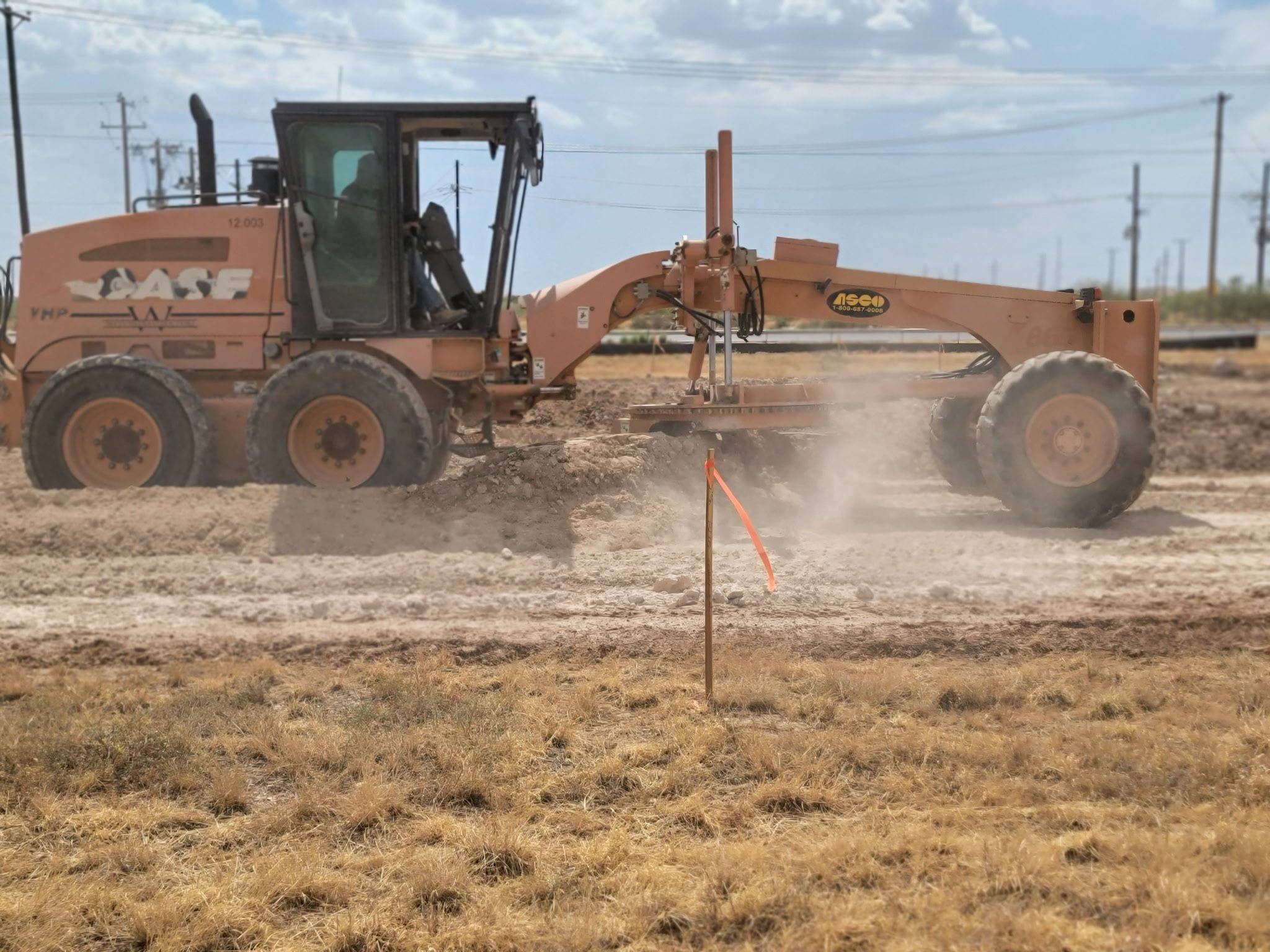 Motor grader shaping a ranch road